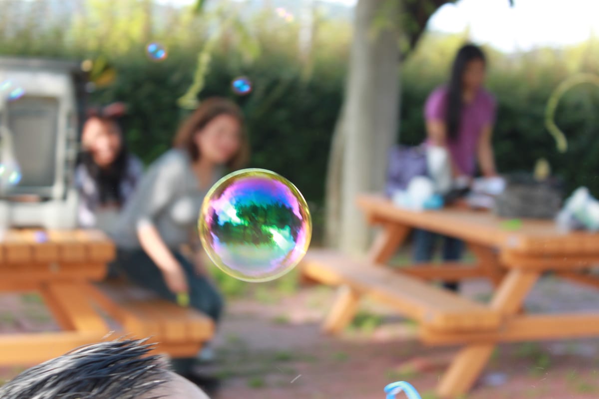 Hire bubble machine — women enjoying outdoor activity with bubbles for parties and events in Johannesburg, Sandton and Randburg