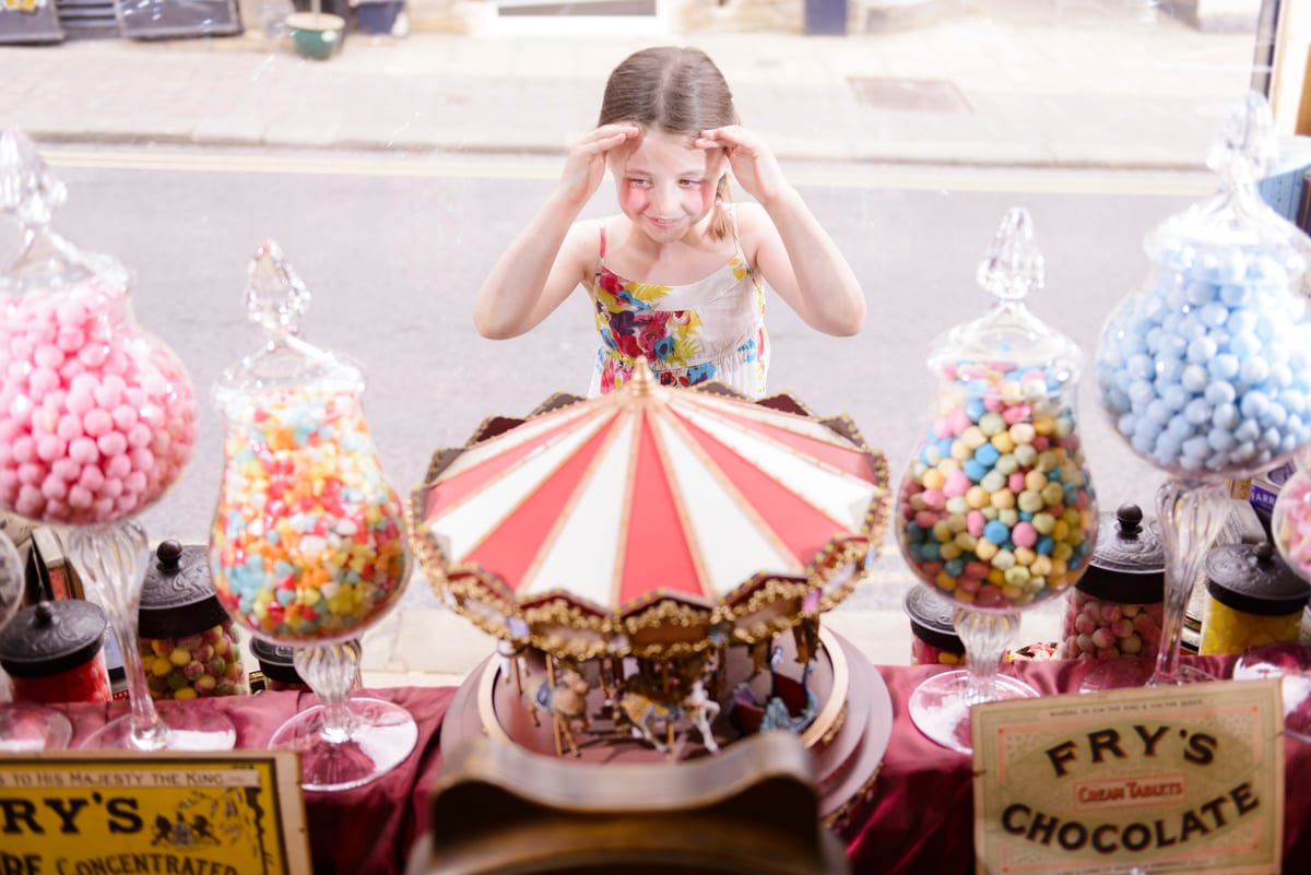 Hire candy cart — girl looking through window of sweet shop for parties and events in Johannesburg, Sandton and Randburg