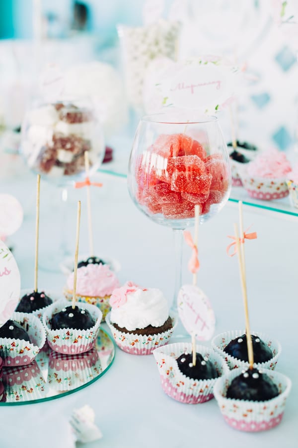Hire candy cart — red candy and cupcakes displayed on table for parties and events in Johannesburg, Sandton and Randburg