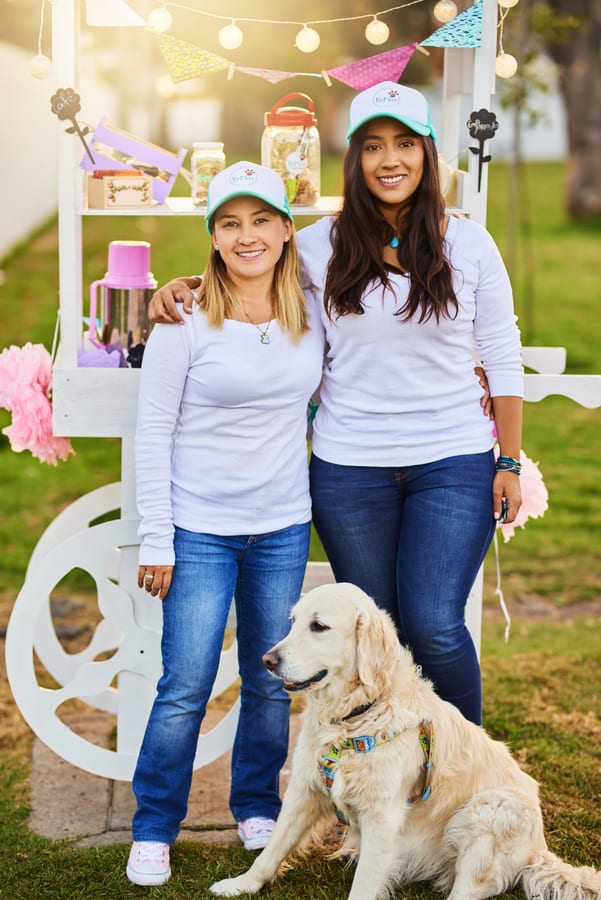 Hire candy cart — smiling women with a dog posing near cart for parties and events in Johannesburg, Sandton and Randburg