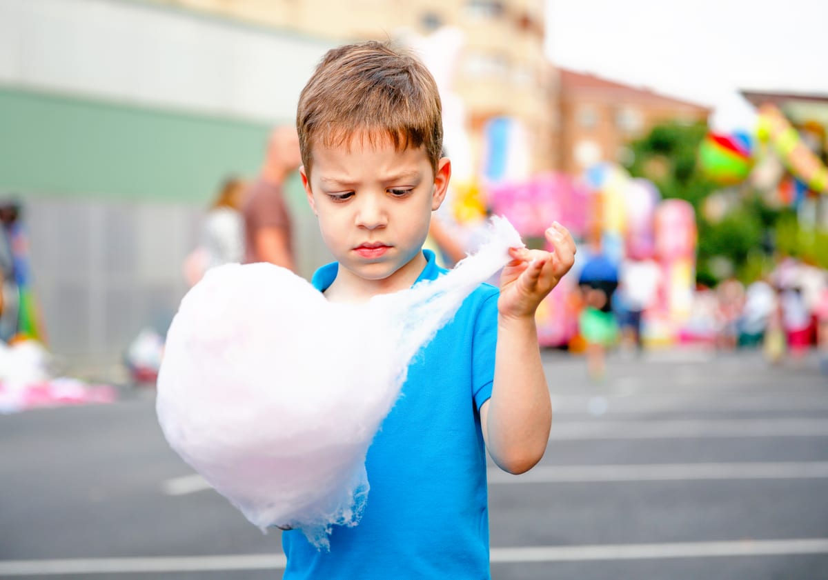 Candy Floss Machine hire — young boy holds large cotton candy outdoors | Panda Party Hire Hire candy floss machine — young boy holds large cotton candy outdoors for parties and events in Johannesburg, Sandton and Randburg