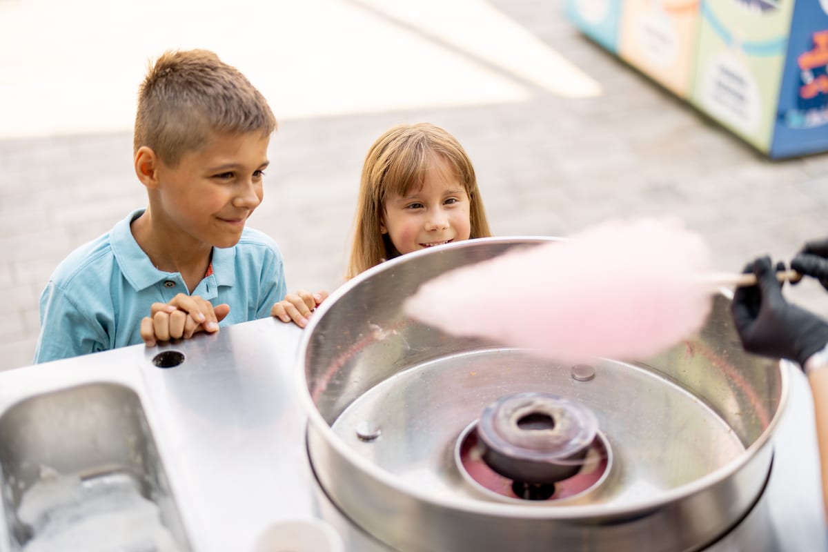 Candy Floss Machine hire — little girl and boy waiting for a sweet cotton can | Panda Party Hire Hire candy floss machine — little girl and boy waiting for a sweet cotton can for parties and events in Johannesburg, Sandton and Randburg
