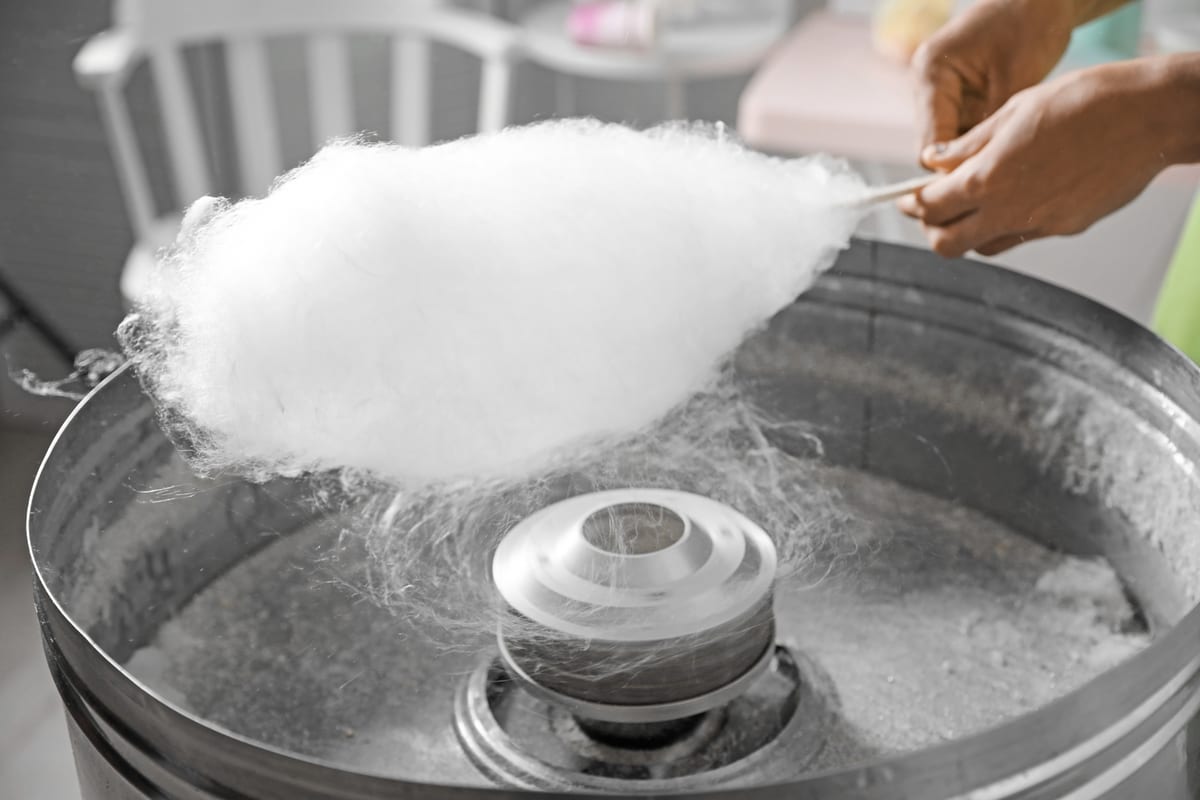 Candy Floss Machine hire — cotton candy being made with hands visible | Panda Party Hire Hire candy floss machine — cotton candy being made with hands visible for parties and events in Johannesburg, Sandton and Randburg