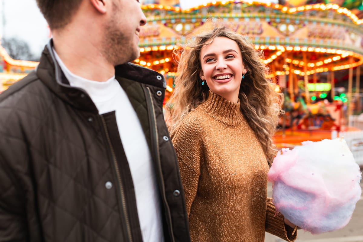 Candy Floss Machine hire — couple having fun and eating cotton candy at amuse | Panda Party Hire Hire candy floss machine — couple having fun and eating cotton candy at amuse for parties and events in Johannesburg, Sandton and Randburg