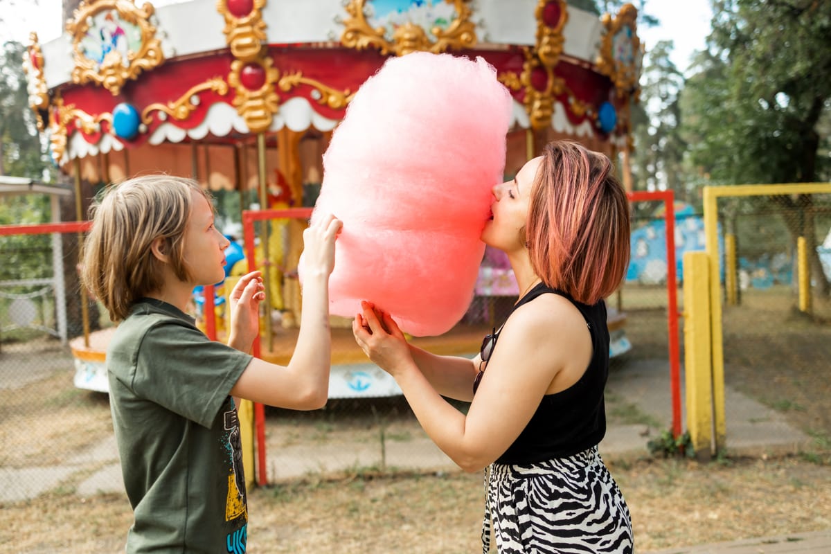 Candy Floss Machine hire — mother and son playing with cotton candy at amusem | Panda Party Hire Hire candy floss machine — mother and son playing with cotton candy at amusem for parties and events in Johannesburg, Sandton and Randburg