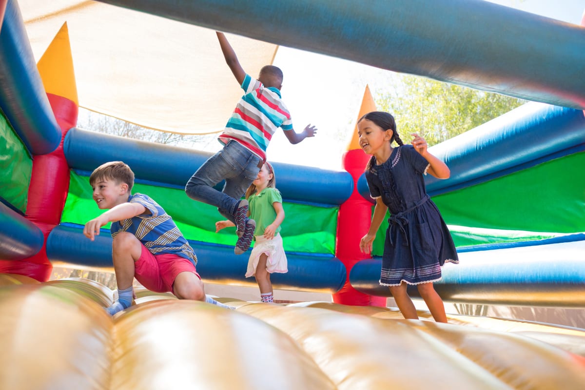 Hire jumping castle — friends jumping on bouncy castle at playground for parties and events in Johannesburg, Sandton and Randburg