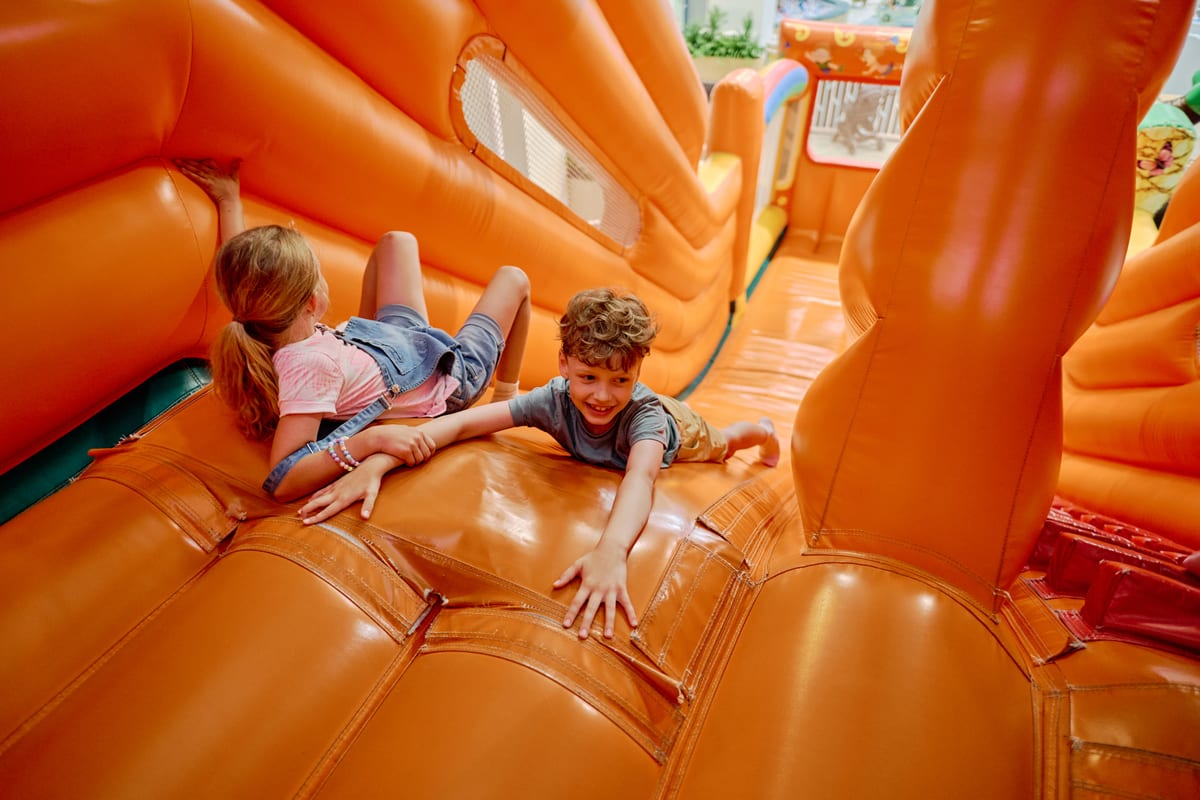 Hire jumping castle — children playing on an orange inflatable structure for parties and events in Johannesburg, Sandton and Randburg