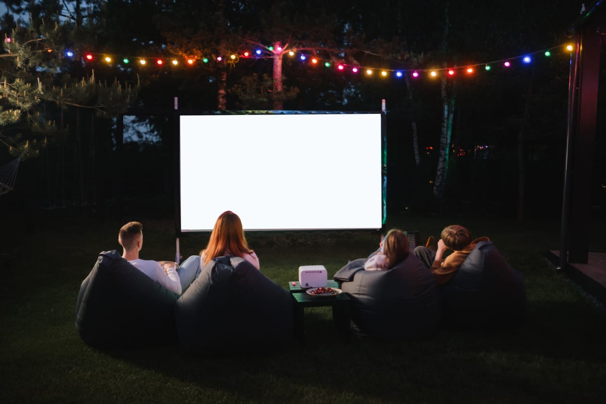 Hire outdoor cinema — friends enjoying outdoor movie night on lawn for parties and events in Johannesburg, Sandton and Randburg