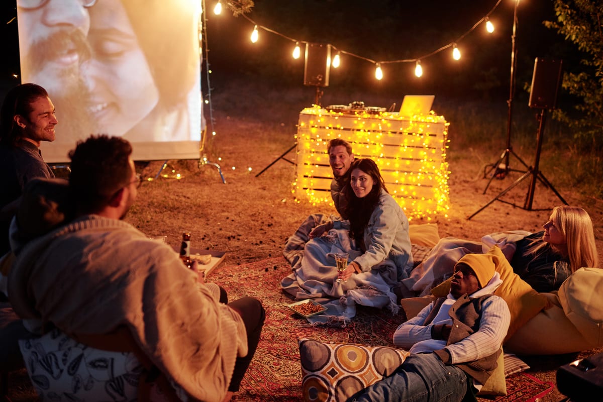 Hire outdoor cinema — friends enjoying outdoor movie night under string for parties and events in Johannesburg, Sandton and Randburg
