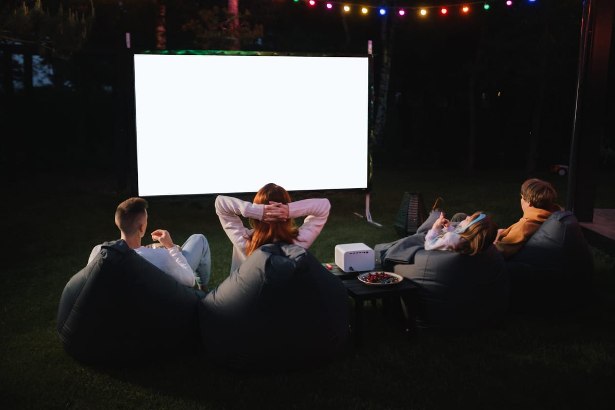 Hire outdoor cinema — friends enjoying an outdoor movie night on lawn for parties and events in Johannesburg, Sandton and Randburg