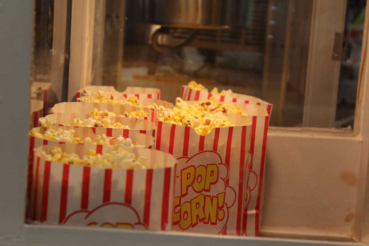 Popcorn machine hire — cinema party with popcorn | Panda Party Hire Hire popcorn machine — guests watching a film with fresh popcorn, perfect alongside outdoor cinema hire