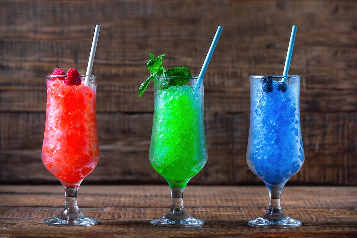 Slush Machine hire — colorful ice drinks on a wooden background | Panda Party Hire Hire slush machine — colorful ice drinks on a wooden background for parties and events in Johannesburg, Sandton and Randburg
