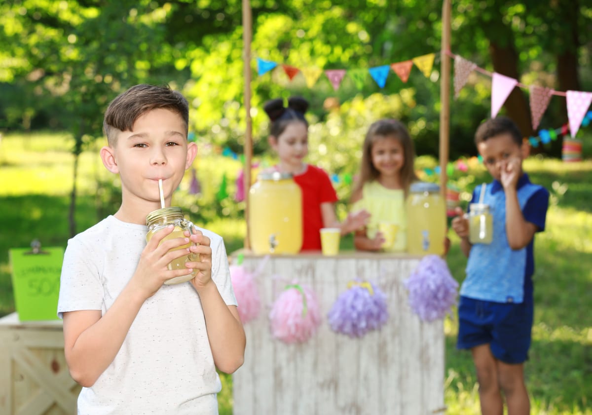 Slush Machine hire — cute little boy drinking natural lemonade in park | Panda Party Hire Hire slush machine — cute little boy drinking natural lemonade in park for parties and events in Johannesburg, Sandton and Randburg