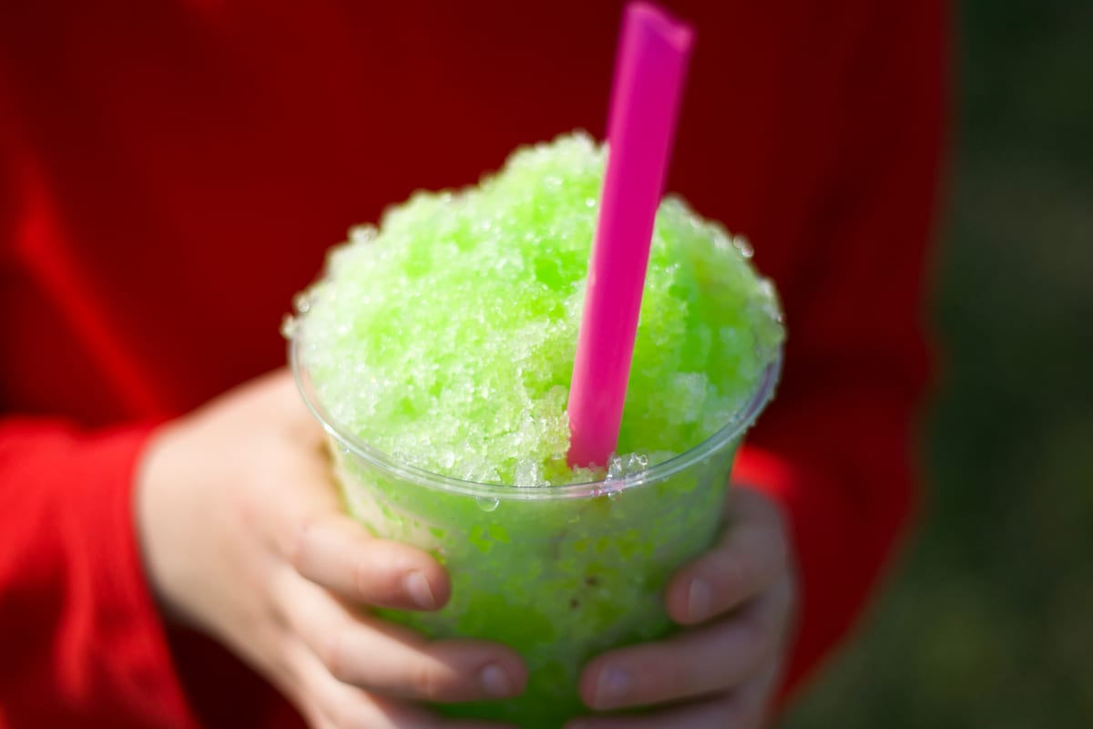 Slush Machine hire — boys hand holding lime green slushy | Panda Party Hire Hire slush machine — boys hand holding lime green slushy for parties and events in Johannesburg, Sandton and Randburg
