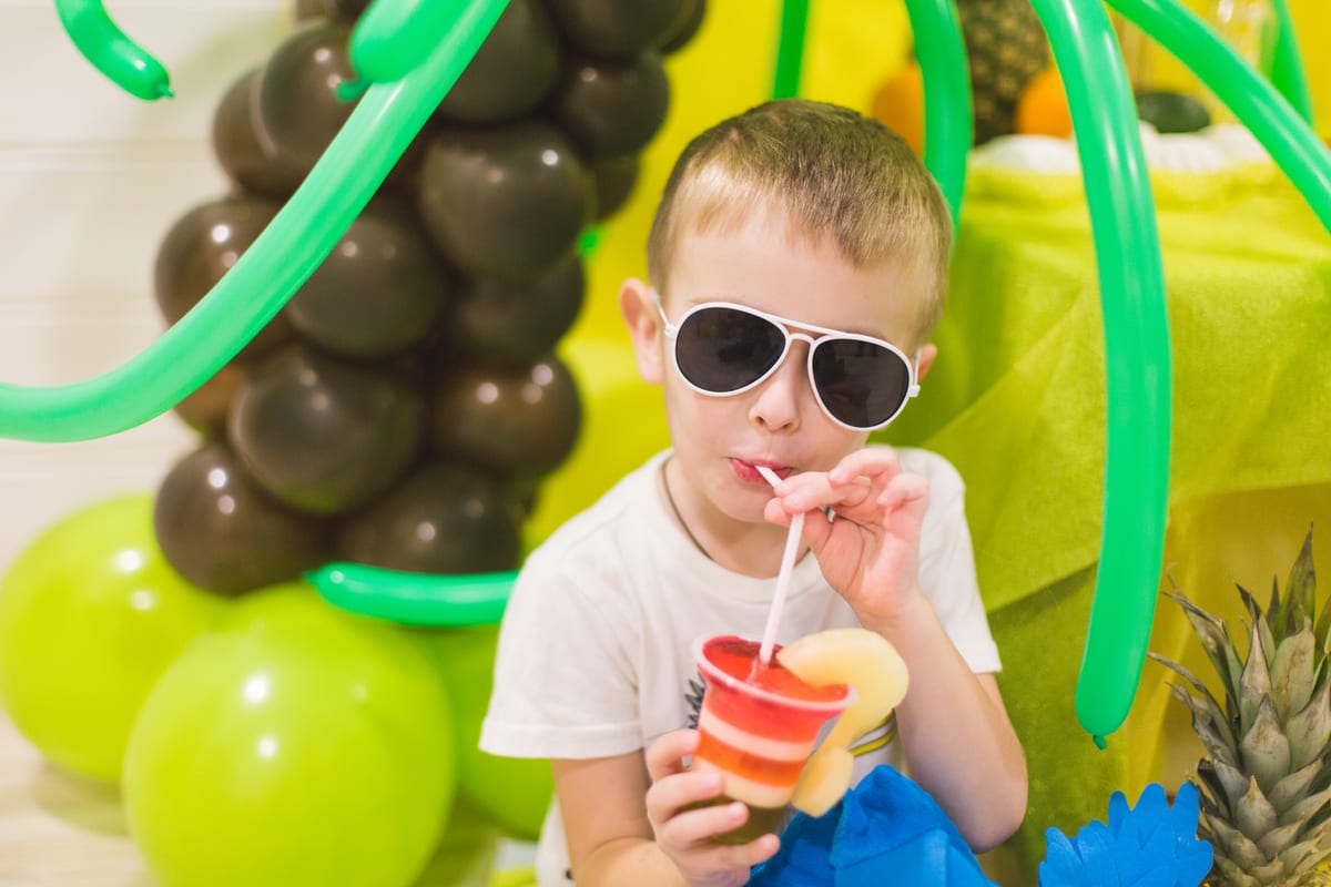 Slush Machine hire — boy with drink surrounded by party decorations | Panda Party Hire Hire slush machine — boy with drink surrounded by party decorations for parties and events in Johannesburg, Sandton and Randburg