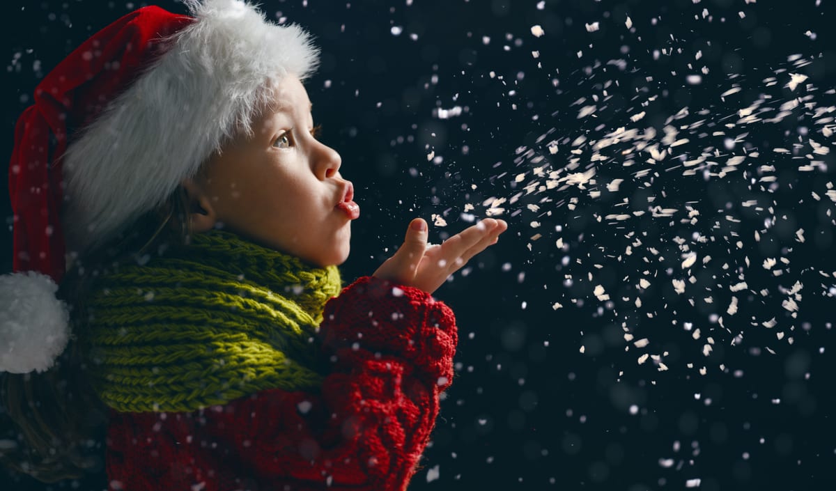 Hire snow machine — girl blowing glitter wearing a santa hat for parties and events in Johannesburg, Sandton and Randburg