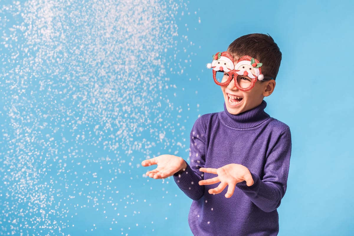 Hire snow machine — boy playing in snow wearing christmas glasses for parties and events in Johannesburg, Sandton and Randburg