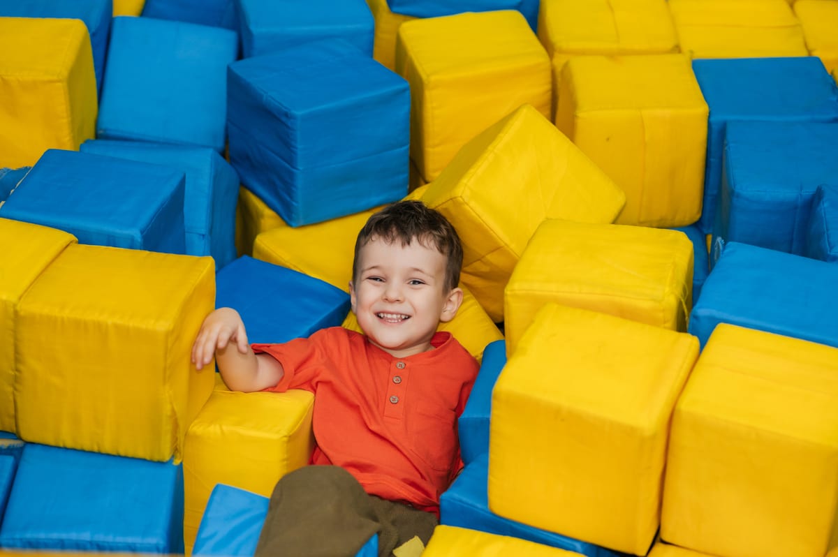 Hire soft play equipment — a boy child plays in a pool with soft cubes a ch for parties and events in Johannesburg, Sandton and Randburg