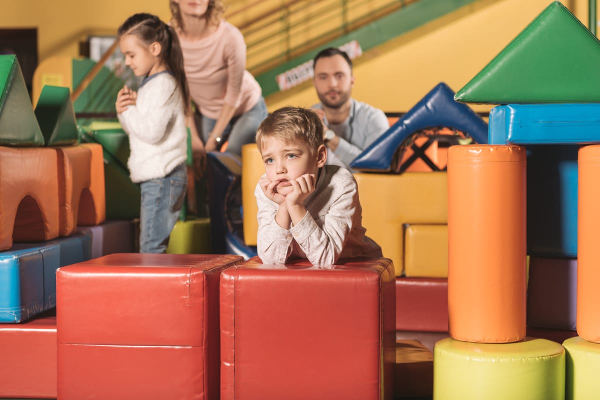 Hire soft play equipment — bored little boy looking away while family playing for parties and events in Johannesburg, Sandton and Randburg