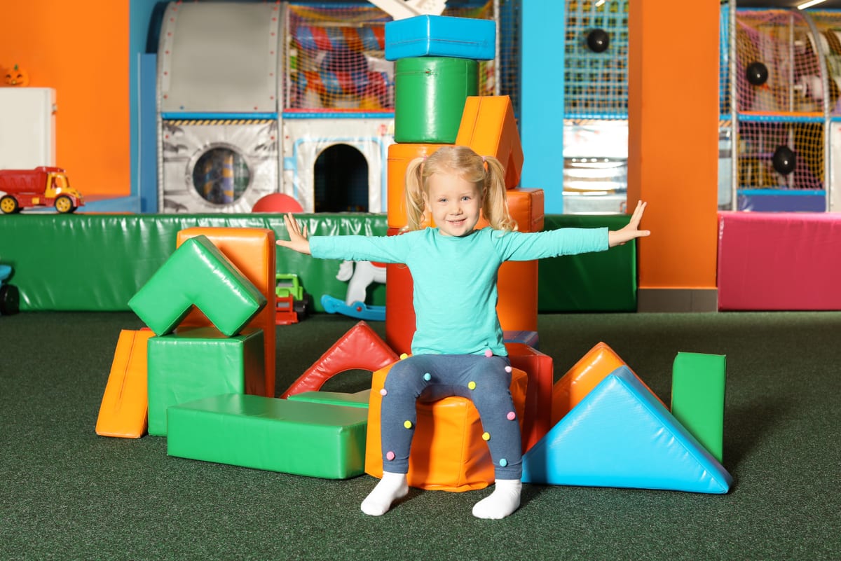 Hire soft play equipment — cute child playing with colorful building blocks for parties and events in Johannesburg, Sandton and Randburg