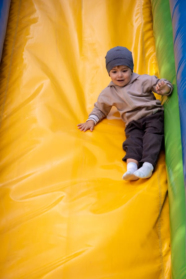 Hire soft play equipment — toddler having fun sliding on inflatable slide for parties and events in Johannesburg, Sandton and Randburg
