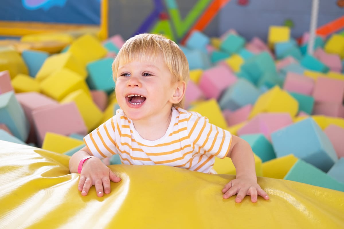 Hire soft play equipment — cute smiling child boy plays with soft cubes in th for parties and events in Johannesburg, Sandton and Randburg
