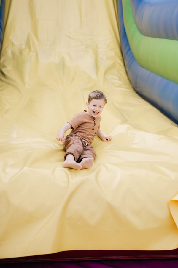 Hire soft play equipment — happy child sliding down inflatable slide at playg for parties and events in Johannesburg, Sandton and Randburg