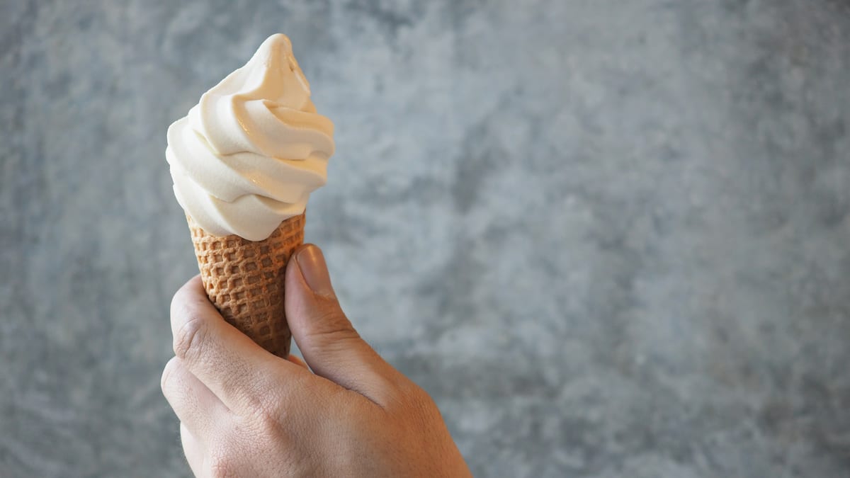 Hire soft serve machine — hand holding delicious vanilla ice cream cone for parties and events in Johannesburg, Sandton and Randburg
