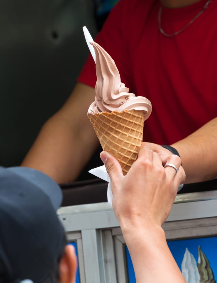 Hire soft serve machine — receiving an ice cream cone from the vendor for parties and events in Johannesburg, Sandton and Randburg