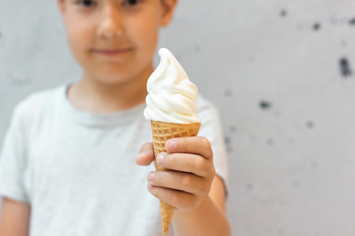 Hire soft serve machine — smiling child holding a tasty ice cream cone for parties and events in Johannesburg, Sandton and Randburg