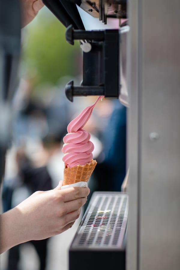 Hire soft serve machine — vertical view of a person s hand holding an ice cr for parties and events in Johannesburg, Sandton and Randburg