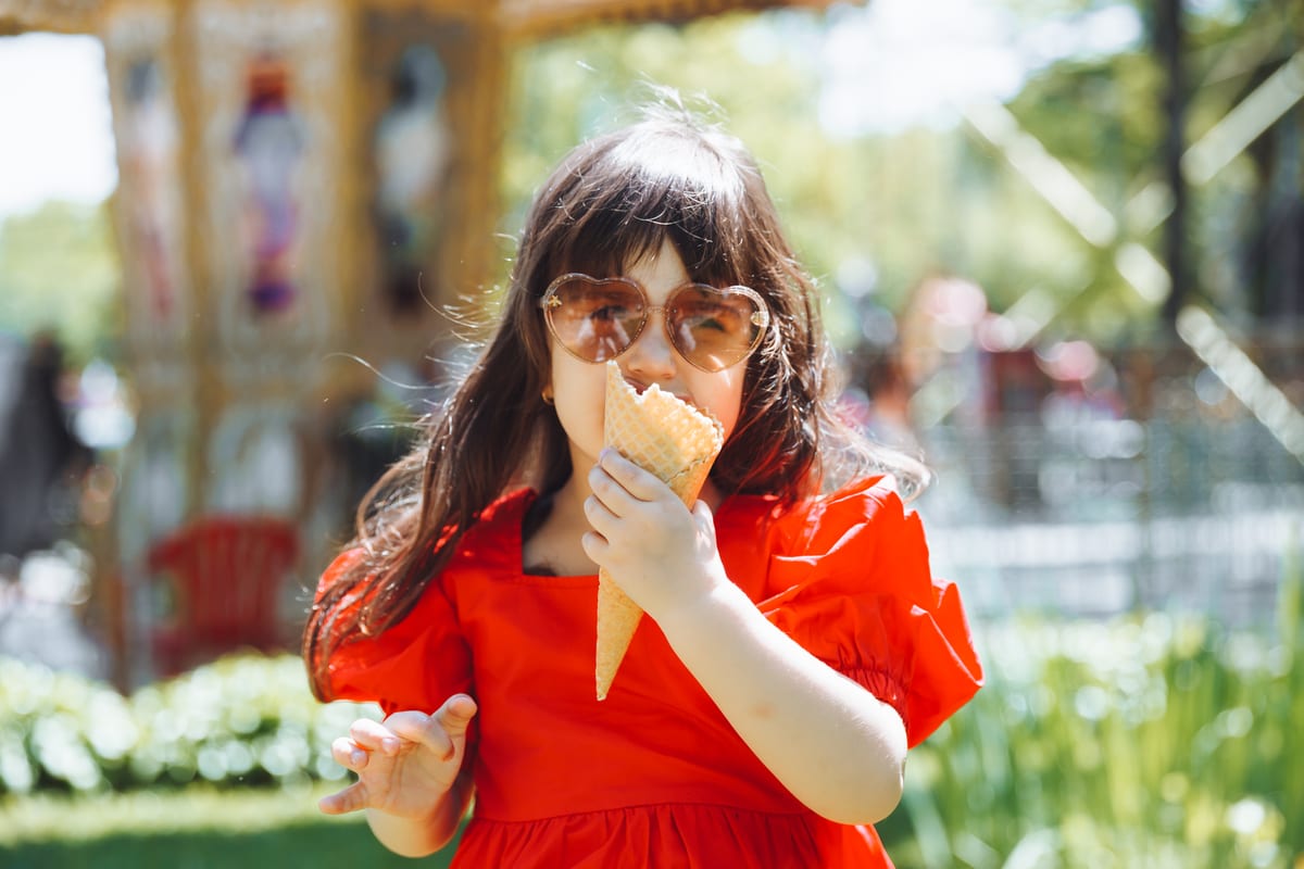 Hire soft serve machine — a little girl in a red dress and a straw hat eats for parties and events in Johannesburg, Sandton and Randburg